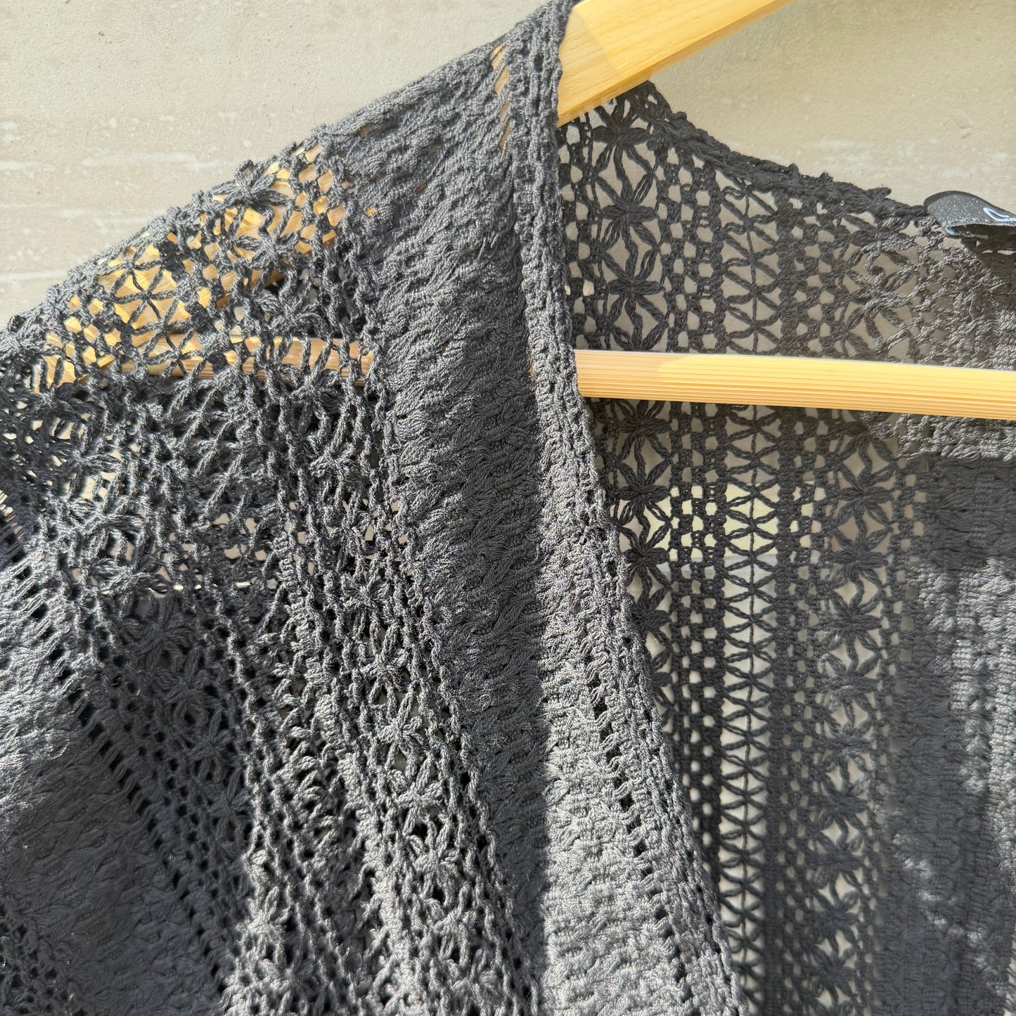 Close-up of a textured black fabric with geometric patterns on a light background