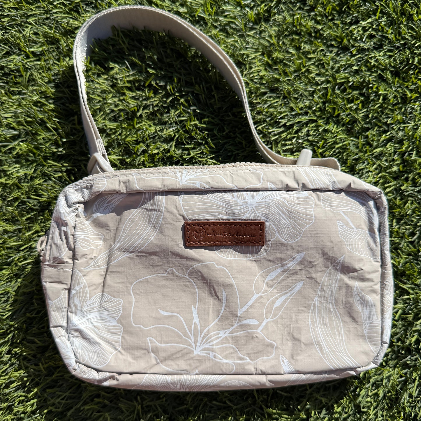 Tan bag on grass