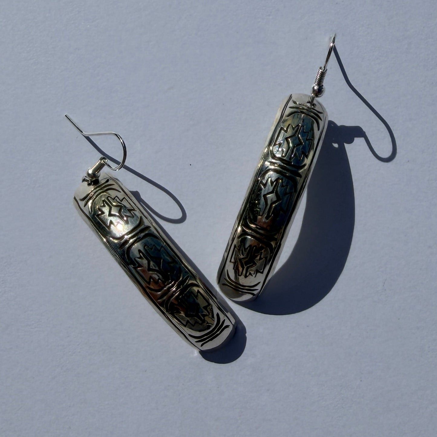 Pair of earrings on a light gray background