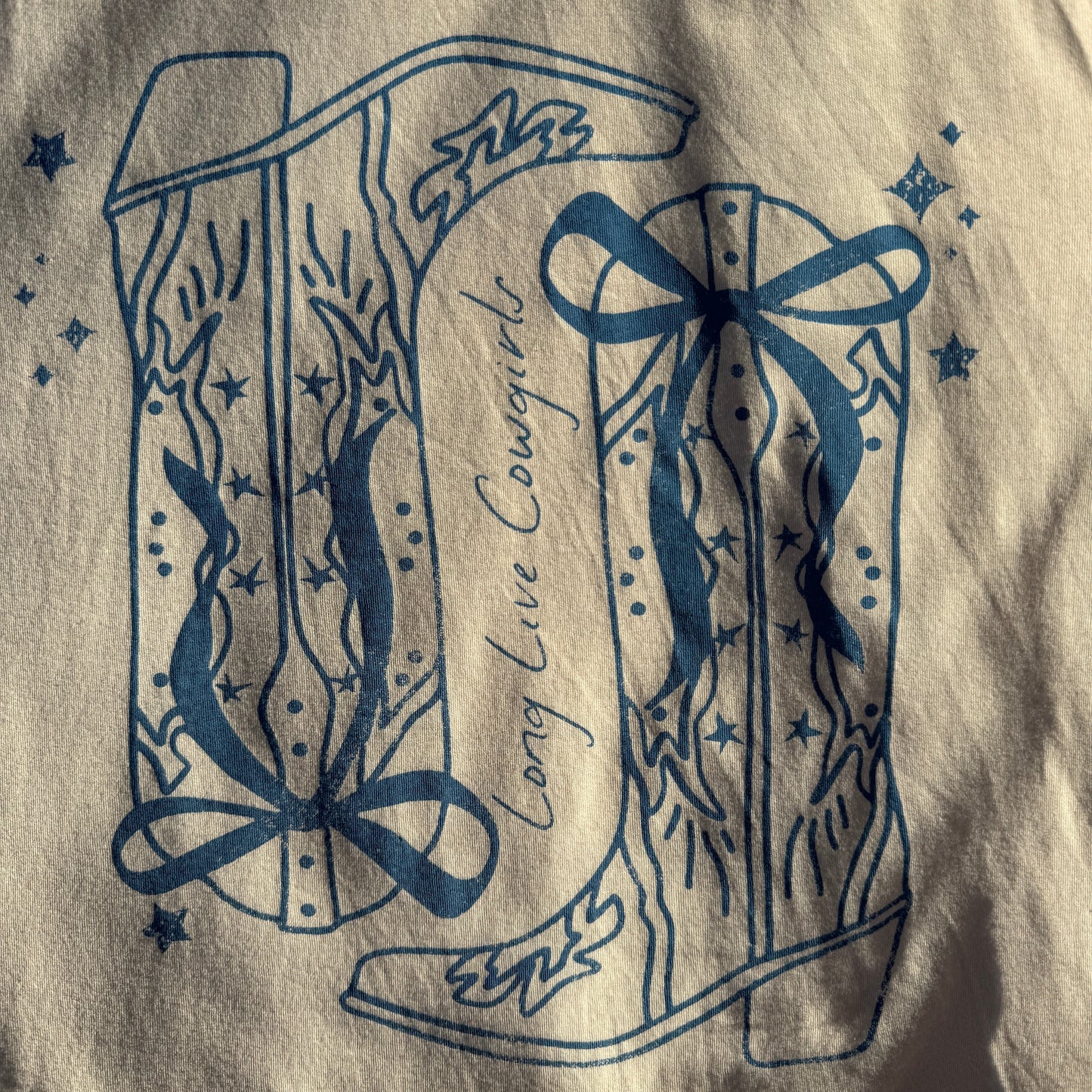 Decorative blue design on a beige fabric background