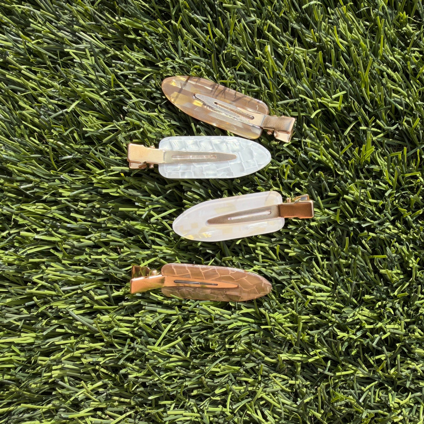 Set of makeup hair clips on grass