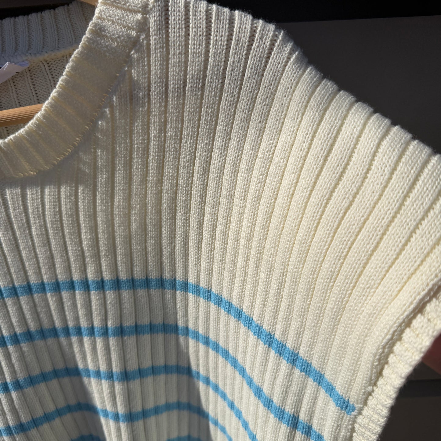 Close-up of a textured fabric with blue lines on a dark background