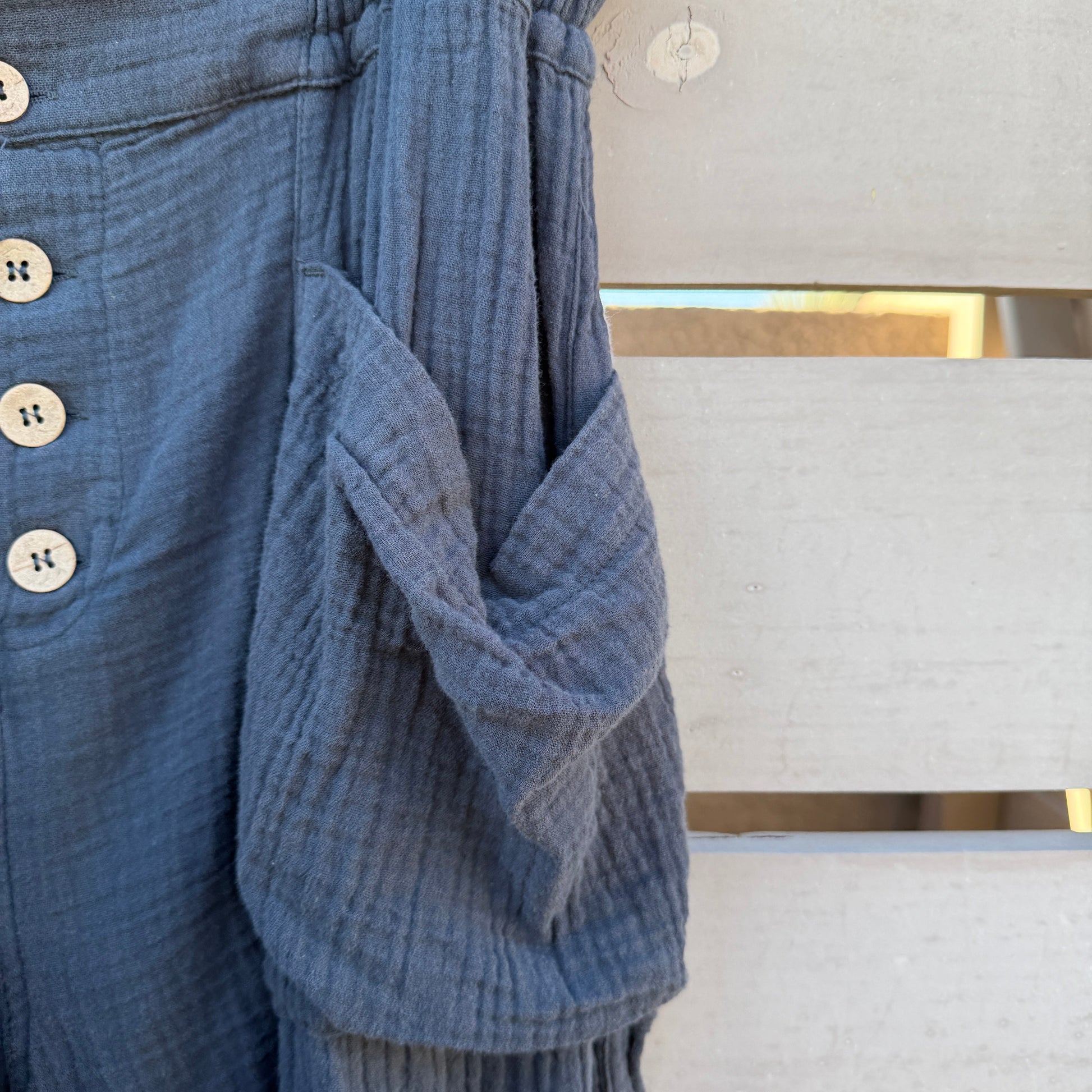 Black textured fabric with buttons on a white background