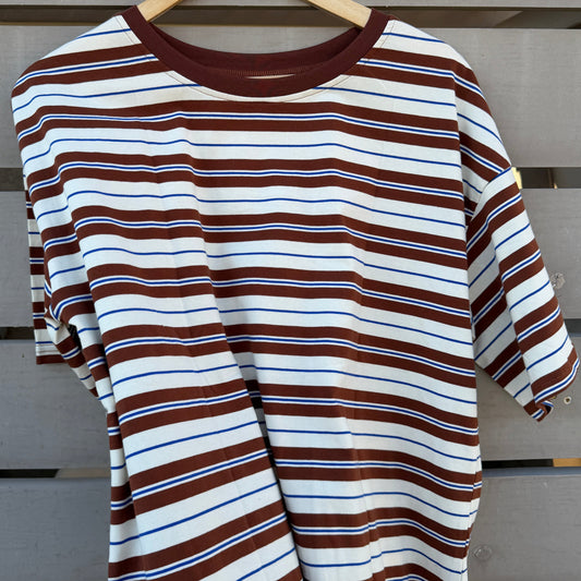 Striped shirt on a hanger against a wooden background