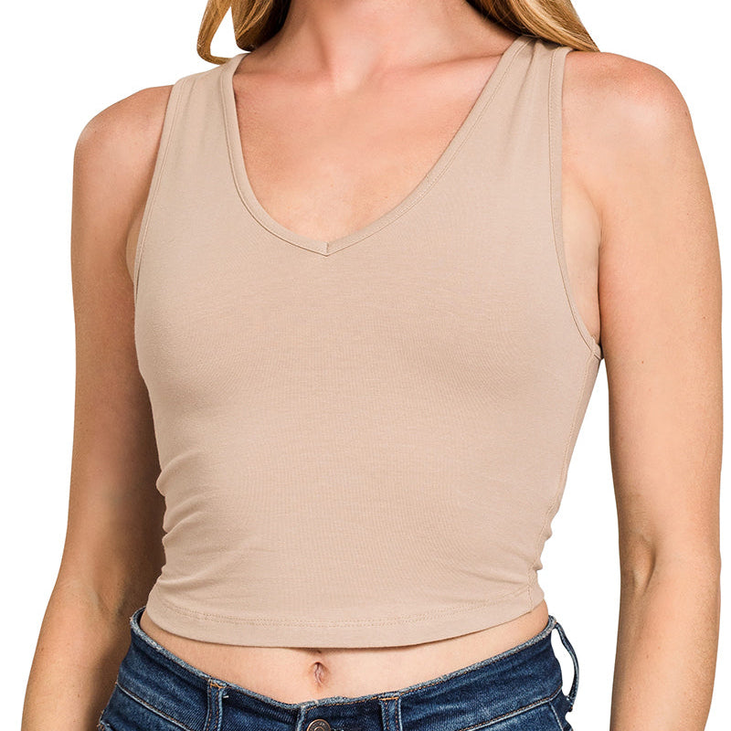 Woman wearing a light brown tank top on a white background