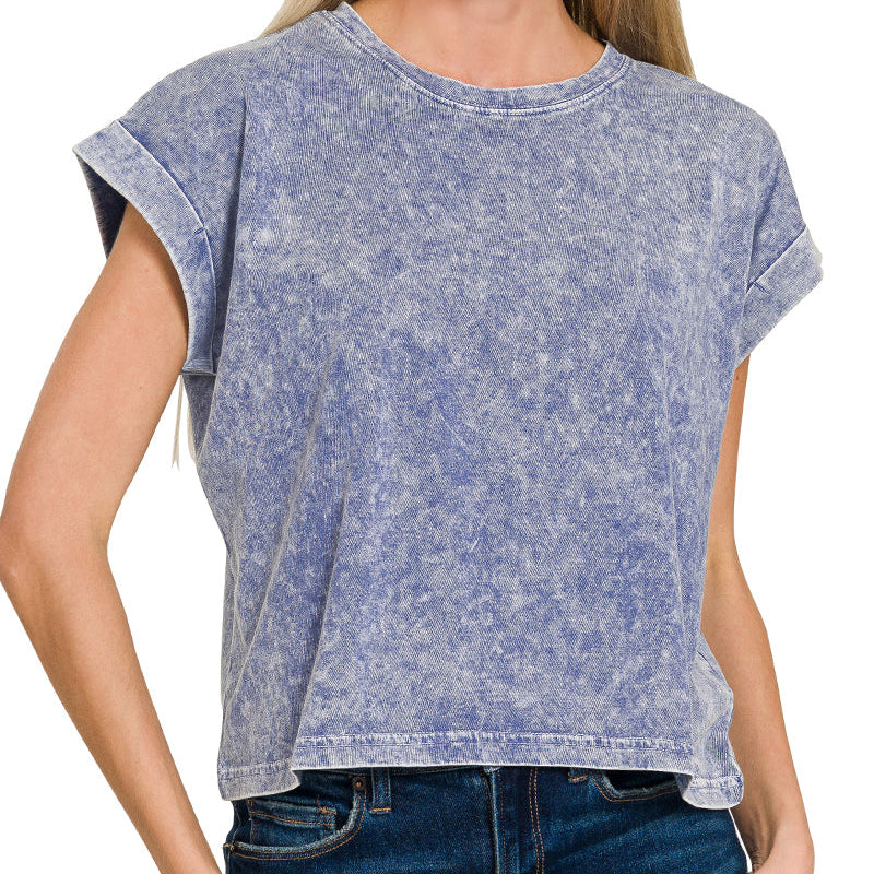 Woman wearing a navy acid-wash t-shirt against a white background