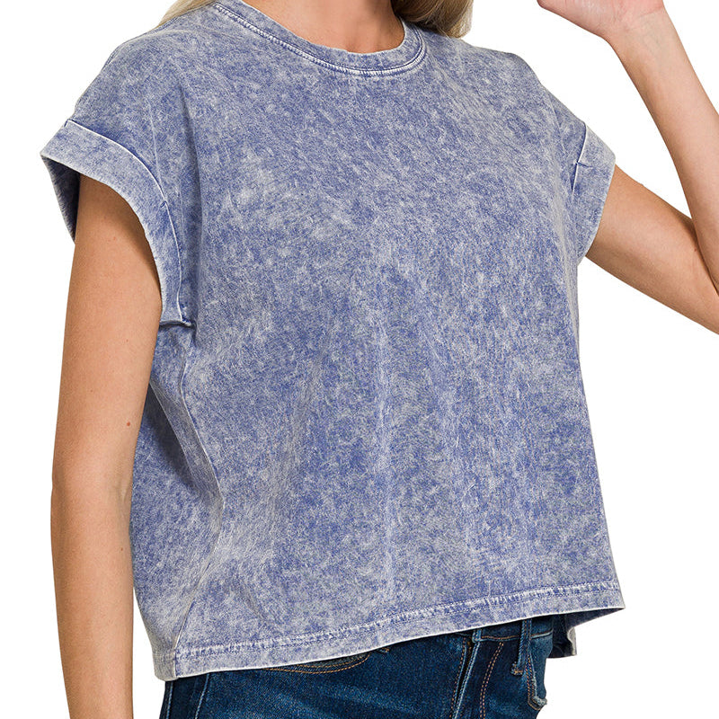 Woman wearing a navy acid-wash t-shirt on a white background