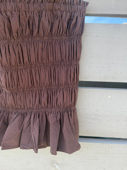 Brown ruffled fabric against a neutral background