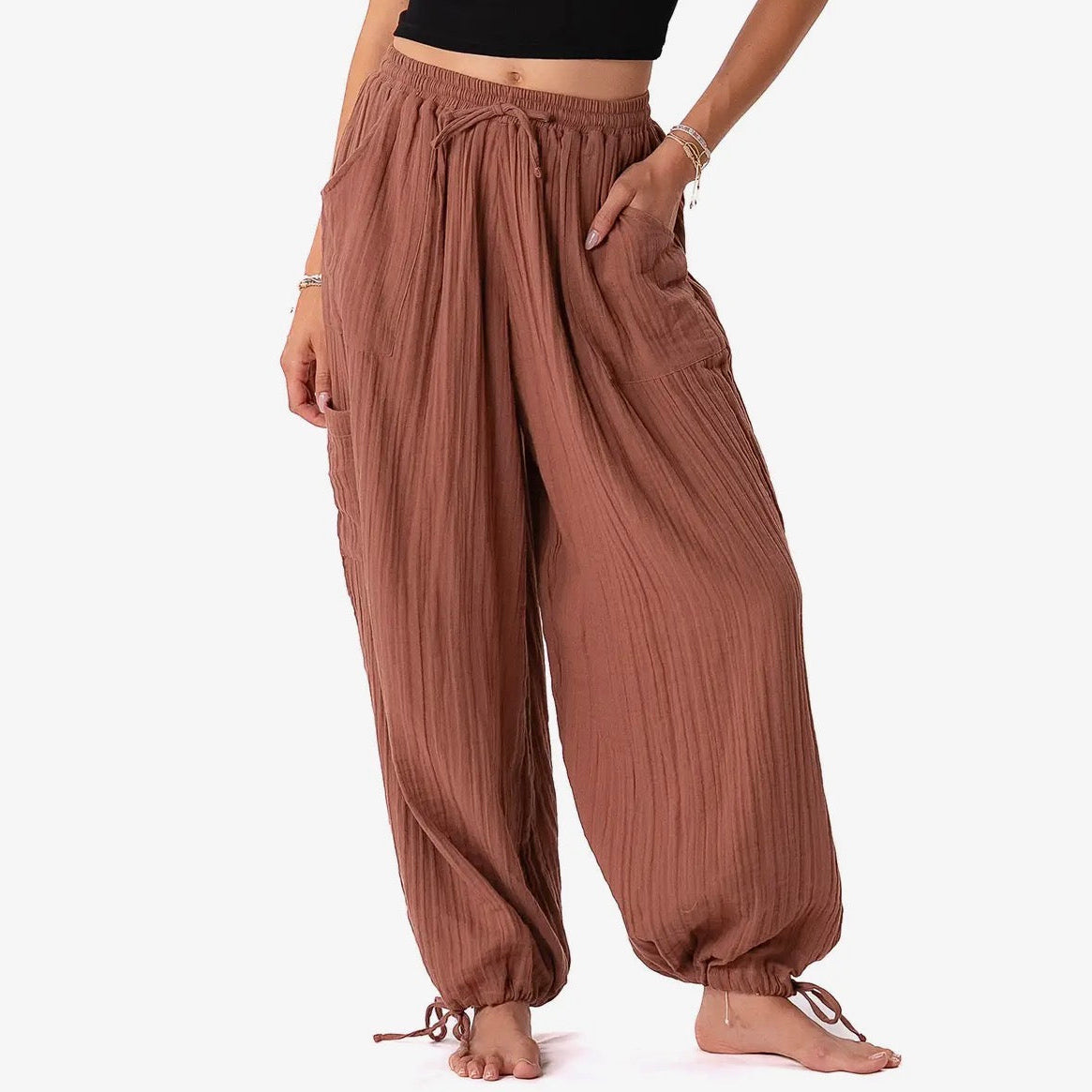 Brown wide-leg pants worn by a person on a white background