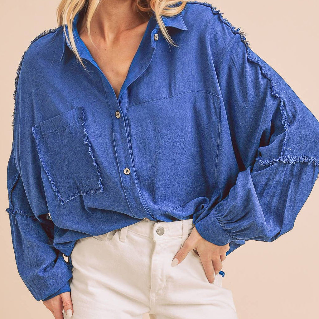 Woman wearing a blue shirt and white shorts on a beige background