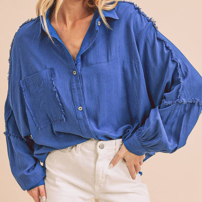 Woman wearing a blue shirt and white shorts on a beige background