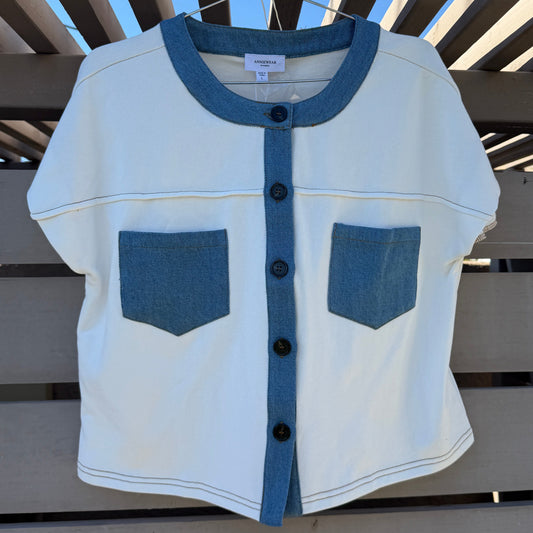 White and blue shirt on a wooden fence against a blue sky.