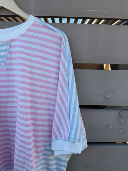 Pink and blue striped shirt on a wooden surface