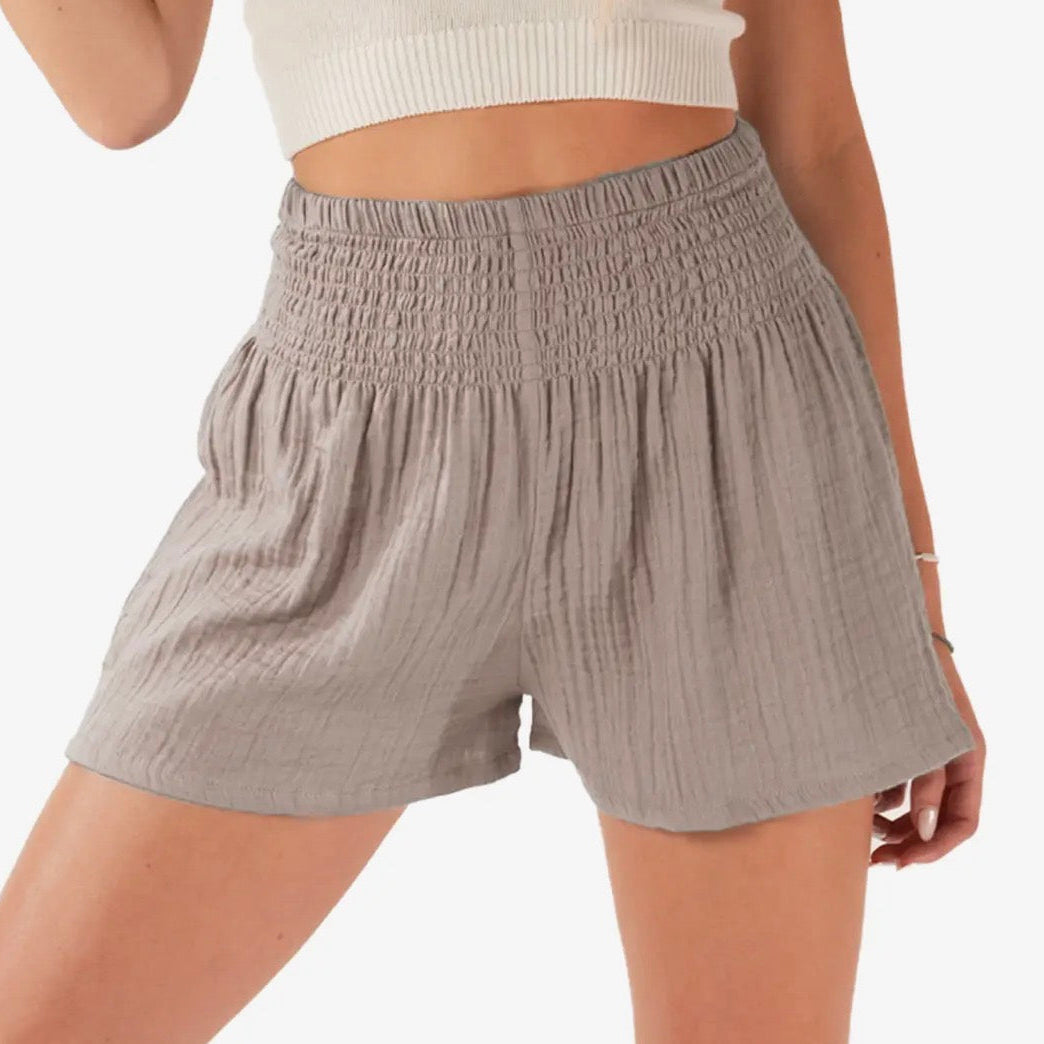 Gray shorts worn by a person on a white background