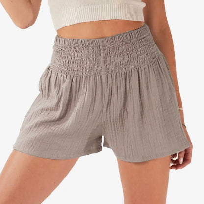 Gray shorts worn by a person on a white background