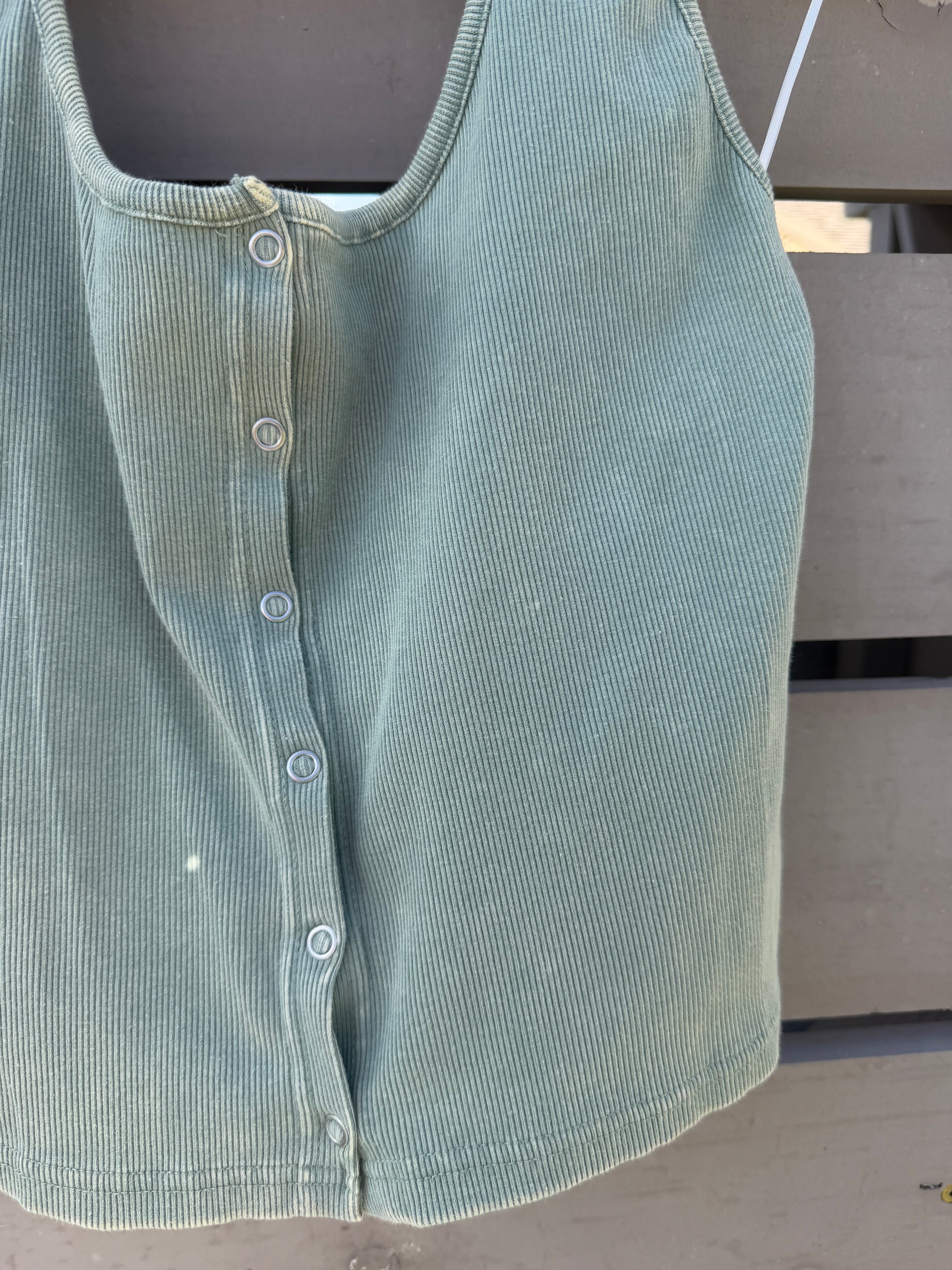 Green corduroy shirt on a dark surface
