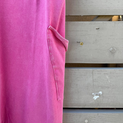 Close-up of a pink jumpsuit with a wooden background
