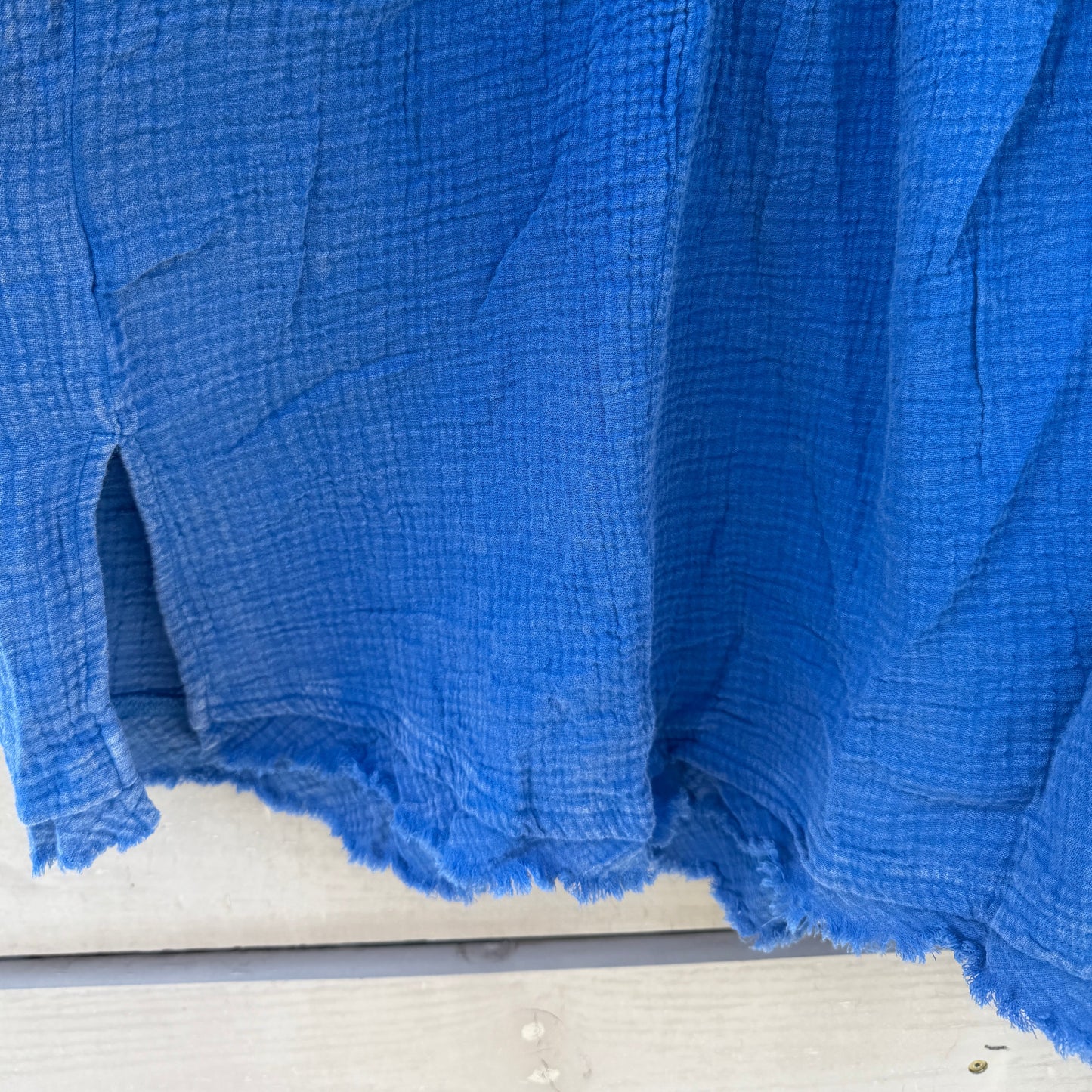 Blue shirt on wooden surface