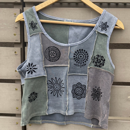Gray tank top with floral patterns on a wooden background