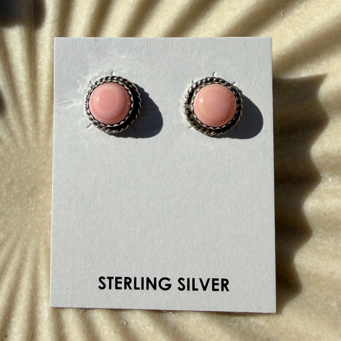 Pink conch studs