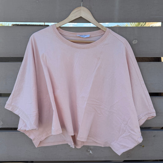 Pink tshirt hanging on a wooden hanger