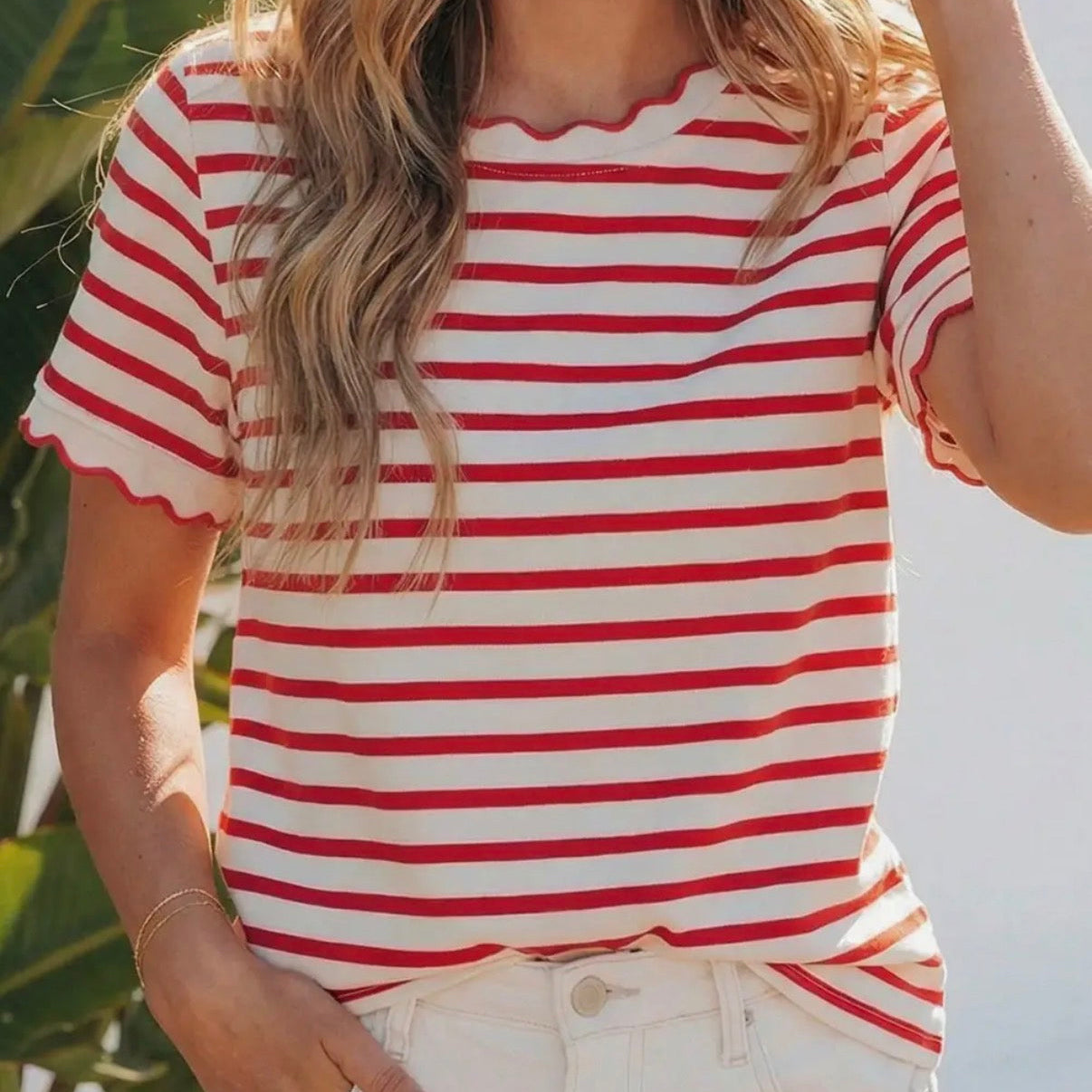 Person wearing a red and white striped shirt with a blurred background
