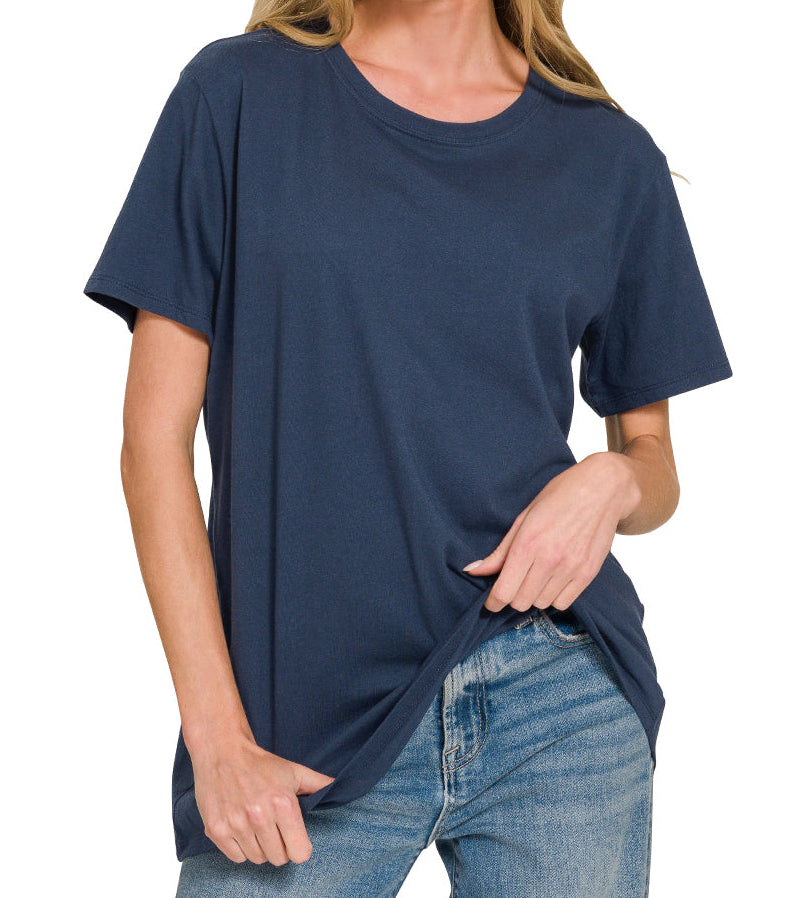 Woman wearing a navy blue t-shirt and jeans on a white background
