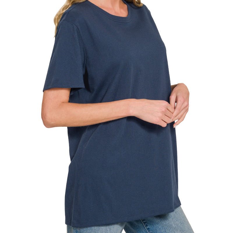 Woman wearing a navy blue t-shirt and jeans on a white background