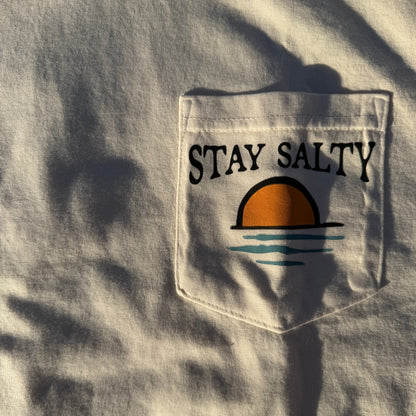 Cream shirt with a pocket featuring 'Stay Salty' text and graphic.