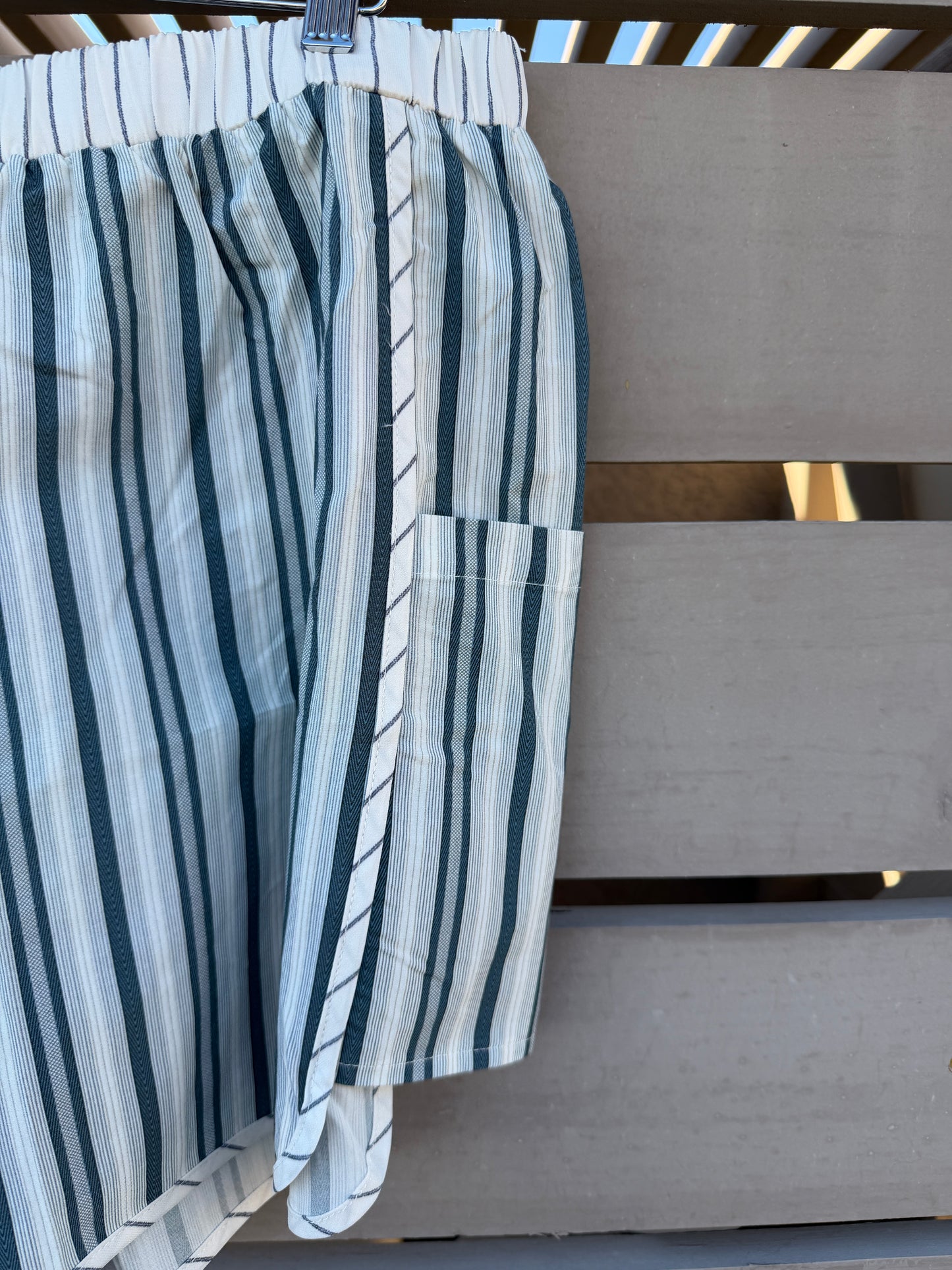 Striped shorts hanging on a wooden surface