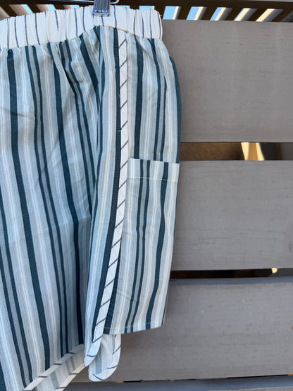 Striped shorts hanging on a wooden surface
