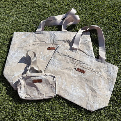 Floral-patterned tote bag and pouch on grass