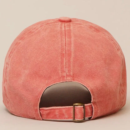Orange baseball cap with a buckle on a beige background