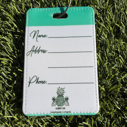 Luggage tag with a brand logo on a grass background