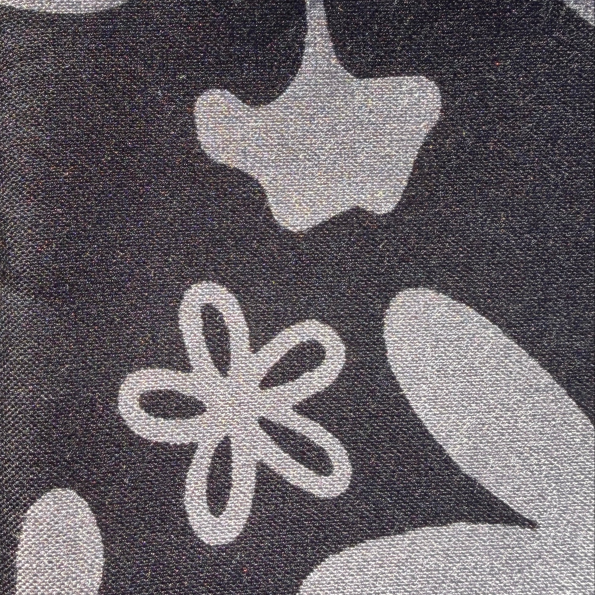 Gray floral-patterned fabric on grass