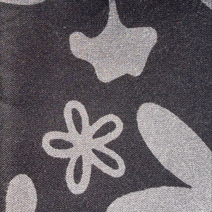 Gray floral-patterned fabric on grass