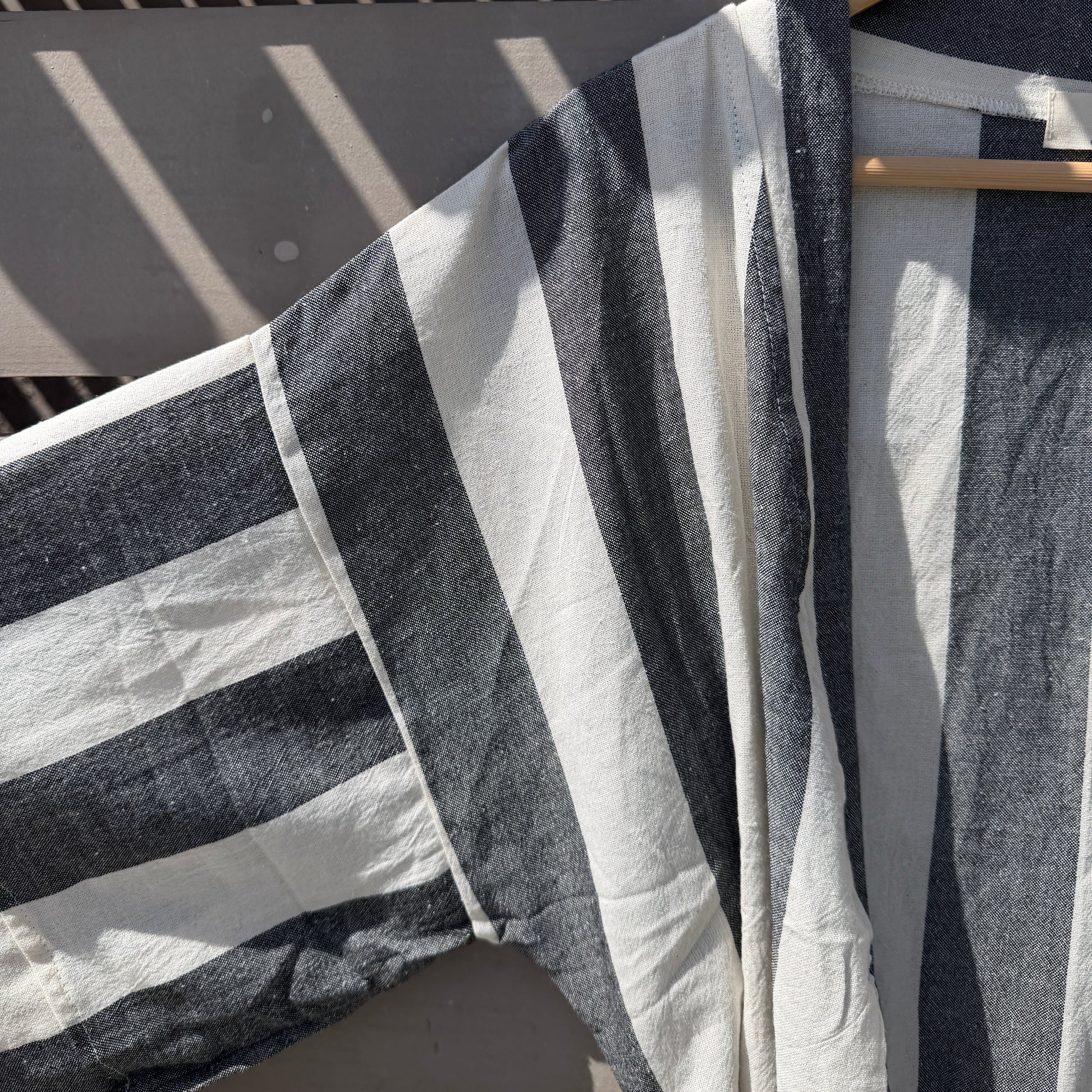 Black and white striped cover up on hanger
