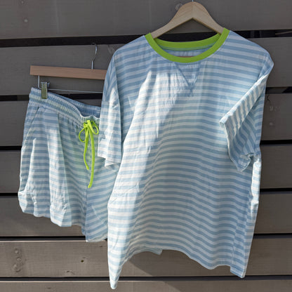 Striped shirt on a hanger against a wooden background