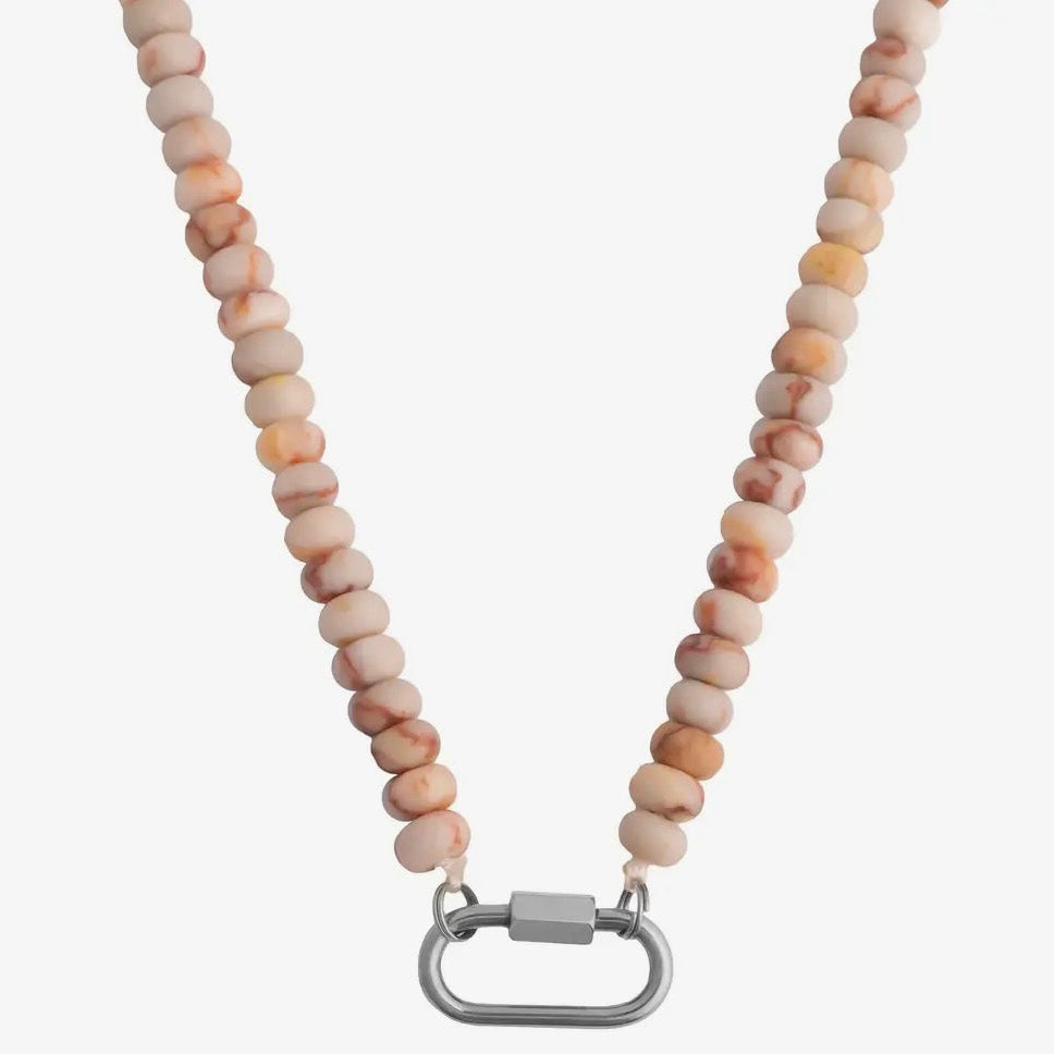Necklace with beige beads and a silver clasp on a white background