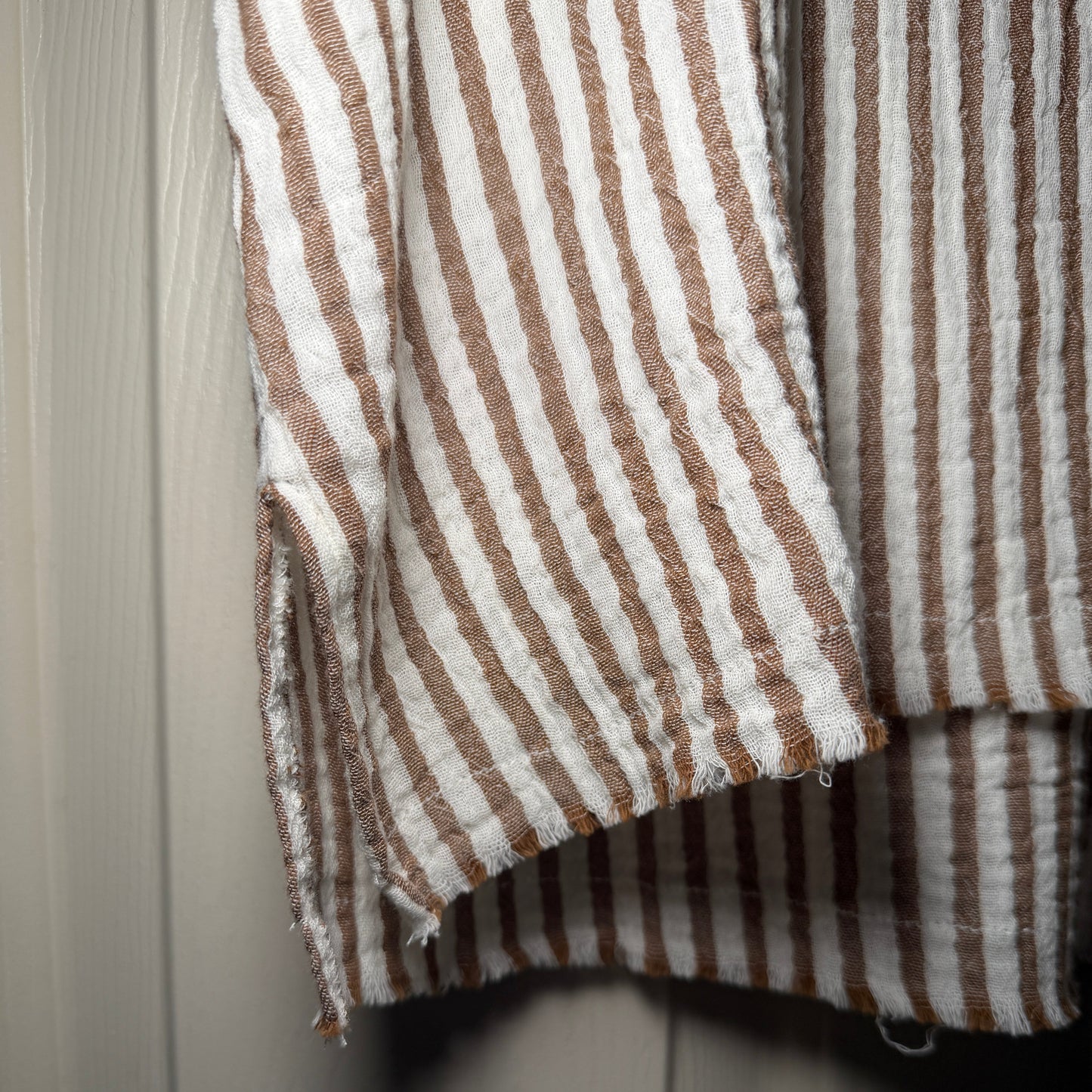 Close-up of brown and white striped fabric on a wooden surface