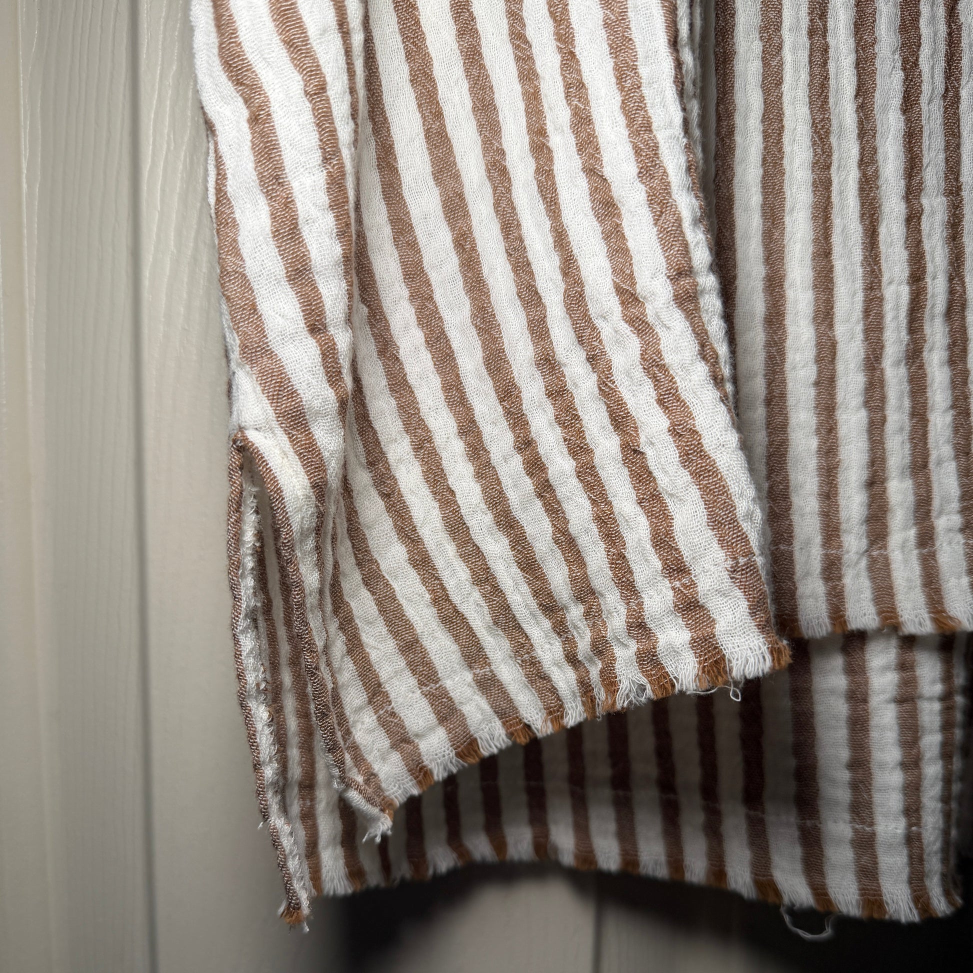 Close-up of brown and white striped fabric on a wooden surface