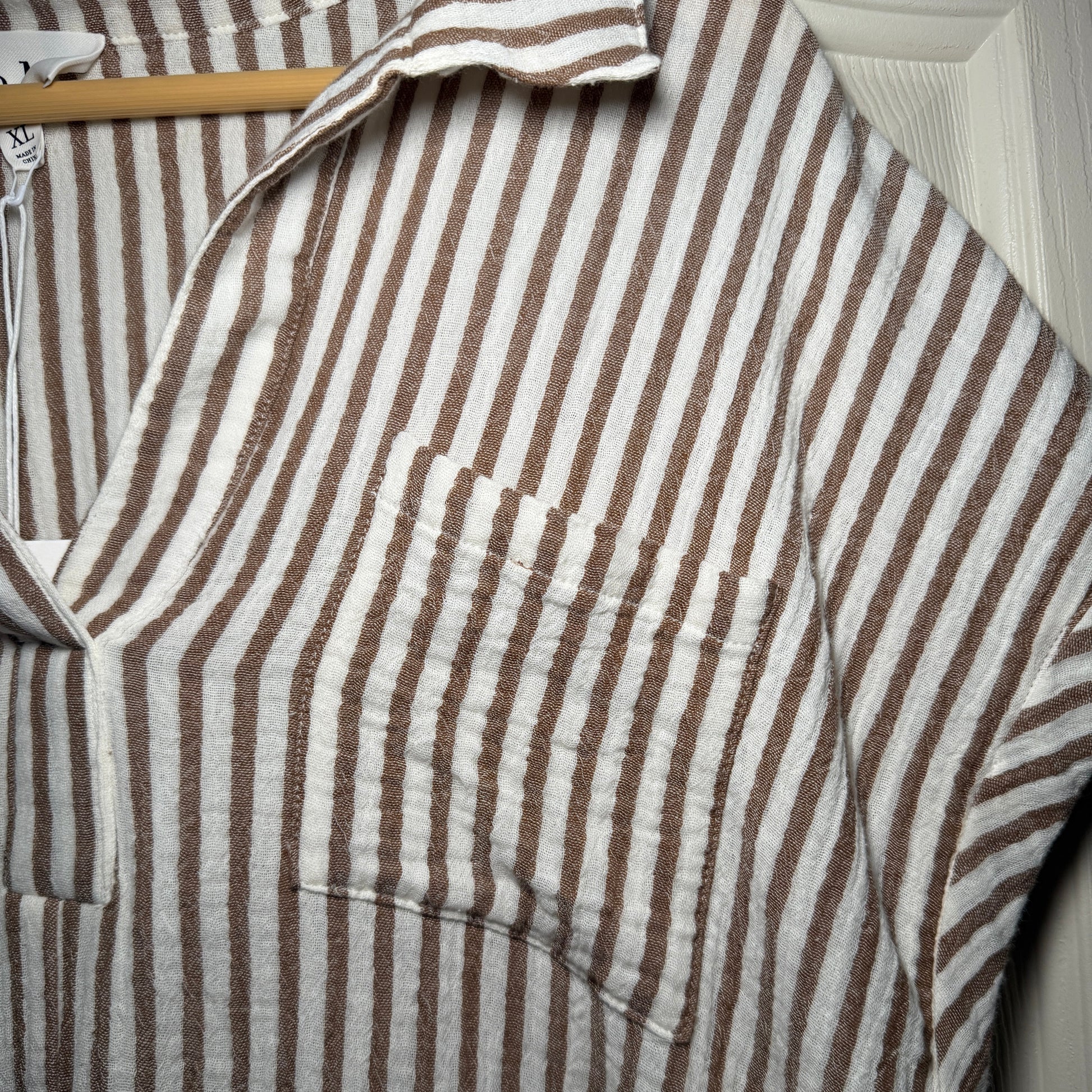 Close-up of a brown and white striped fabric on a wooden surface