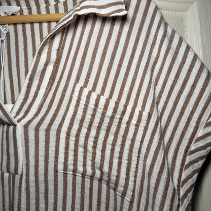 Close-up of a brown and white striped fabric on a wooden surface