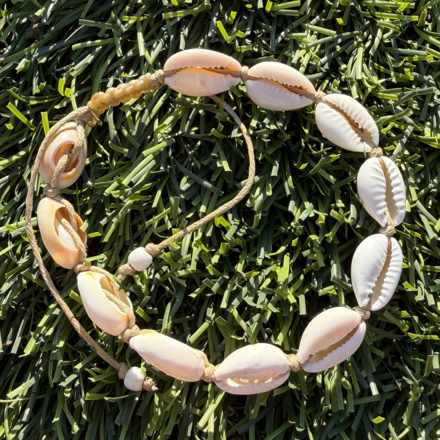 Shell bracelet on artificial grass