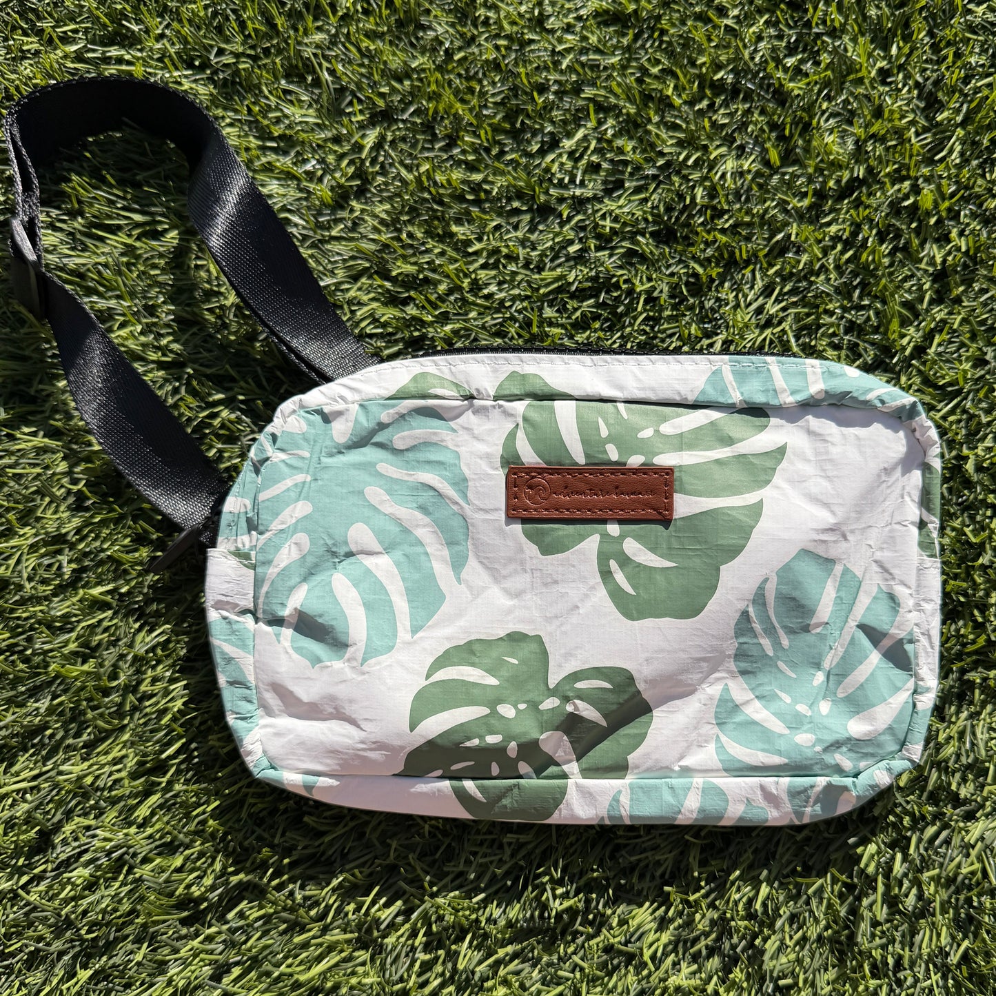 Small pouch with leaf pattern on grass