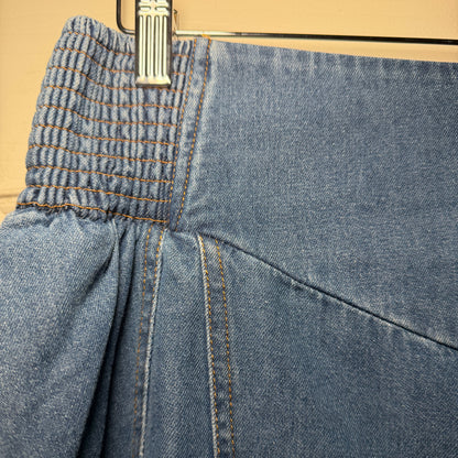 Close-up of blue jeans with a zipper on a beige background