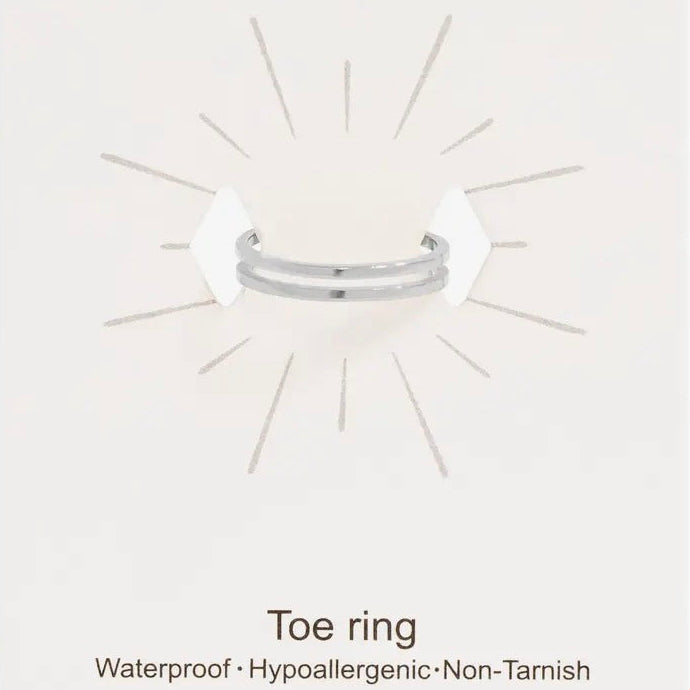 Silver toe ring on a white card