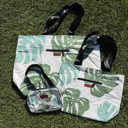 Set of tote bags with leaf pattern on a grass background