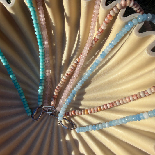 Necklace with colorful beads on a textured surface