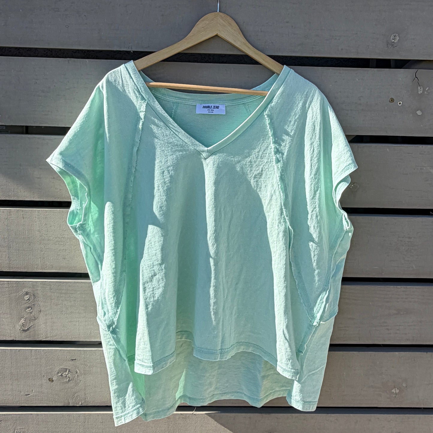 Green shirt on a wooden surface